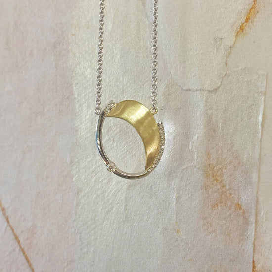 Photo of Oval Necklace with Diamond Accents in a decorative scene, designed by , available at Plumb Gold & Plumb Silver