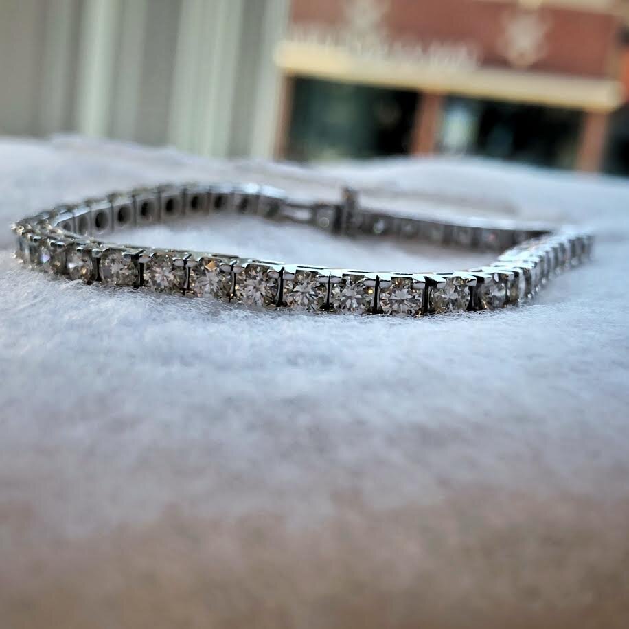 Photo of PGO Diamond Tennis Bracelet in a decorative scene, designed by , available at Plumb Gold & Plumb Silver