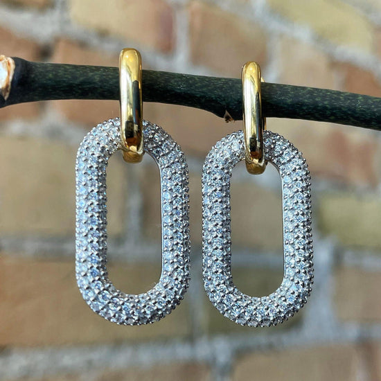 Photo of Paper Clip Cubic Zirconia Earrings in a decorative scene, designed by , available at Plumb Gold & Plumb Silver
