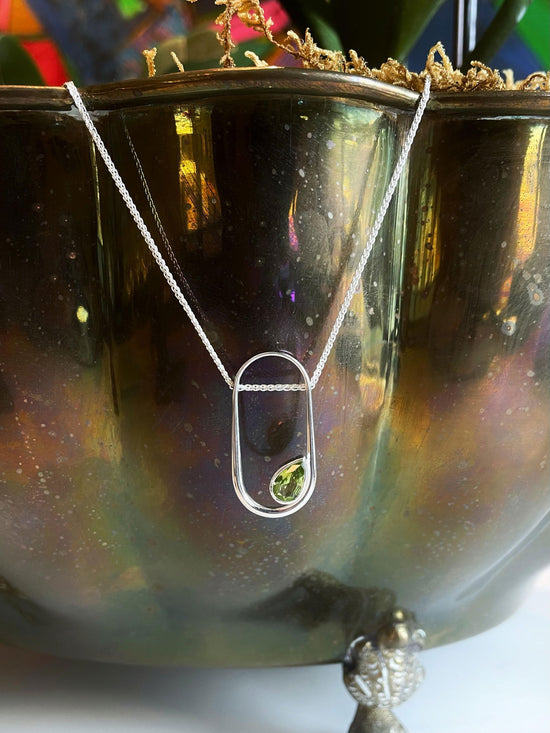 Photo of "Paragon" Pendant in a decorative scene, designed by , available at Plumb Gold & Plumb Silver