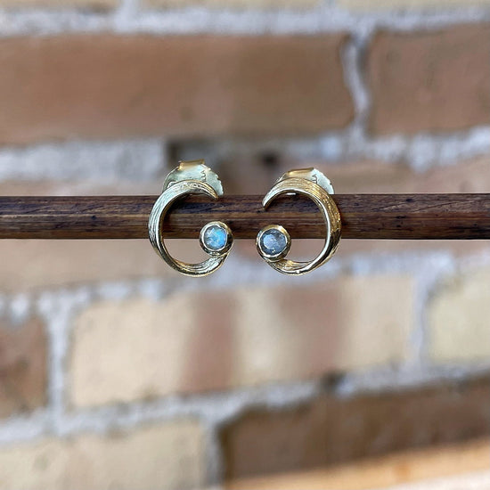Photo of “Peacock” Labradorite Studs in a decorative scene, designed by , available at Plumb Gold & Plumb Silver