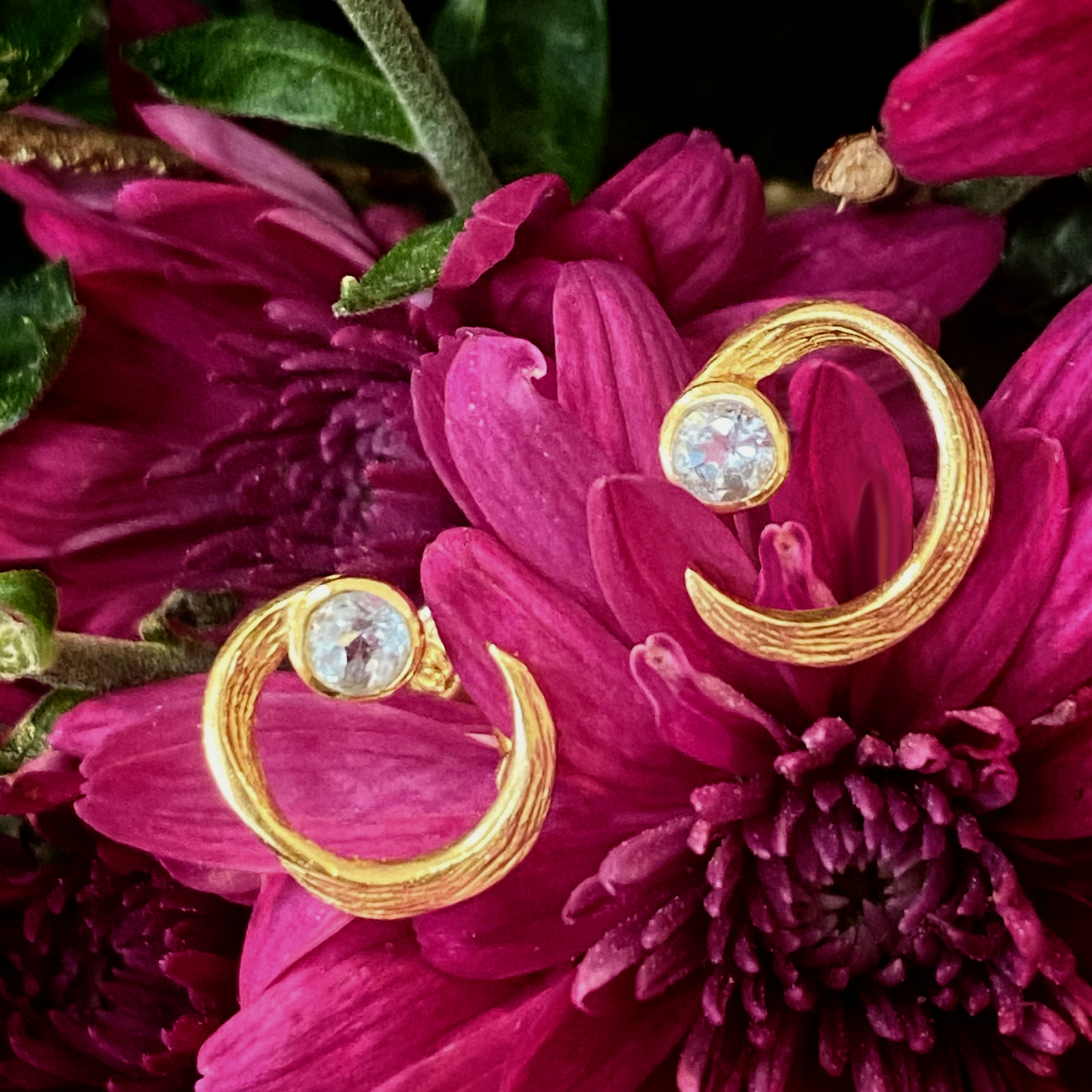 Photo of “Peacock” Studs in a decorative scene, designed by -, available at Plumb Gold & Plumb Silver