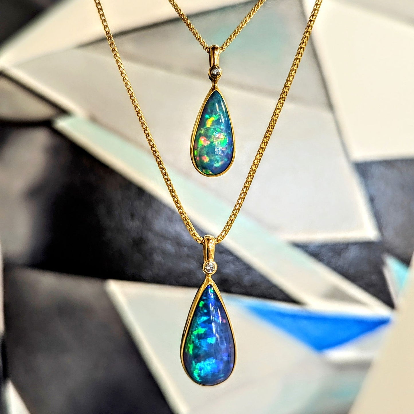 Photo of Pear Drop Opal Pendant in a decorative scene, designed by , available at Plumb Gold & Plumb Silver