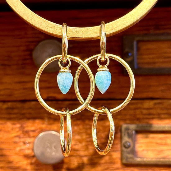 Photo of Pendulum Earring in a decorative scene, designed by -, available at Plumb Gold & Plumb Silver