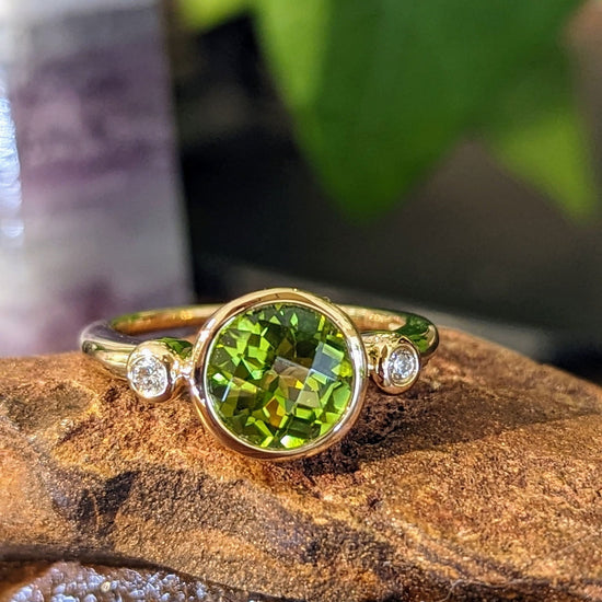 Photo of Peridot and Diamond Ring in a decorative scene, designed by , available at Plumb Gold & Plumb Silver