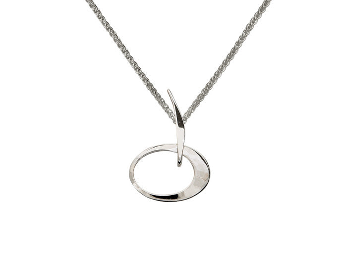 Photo of "Petite Elliptical" Necklace in a decorative scene, designed by , available at Plumb Gold & Plumb Silver