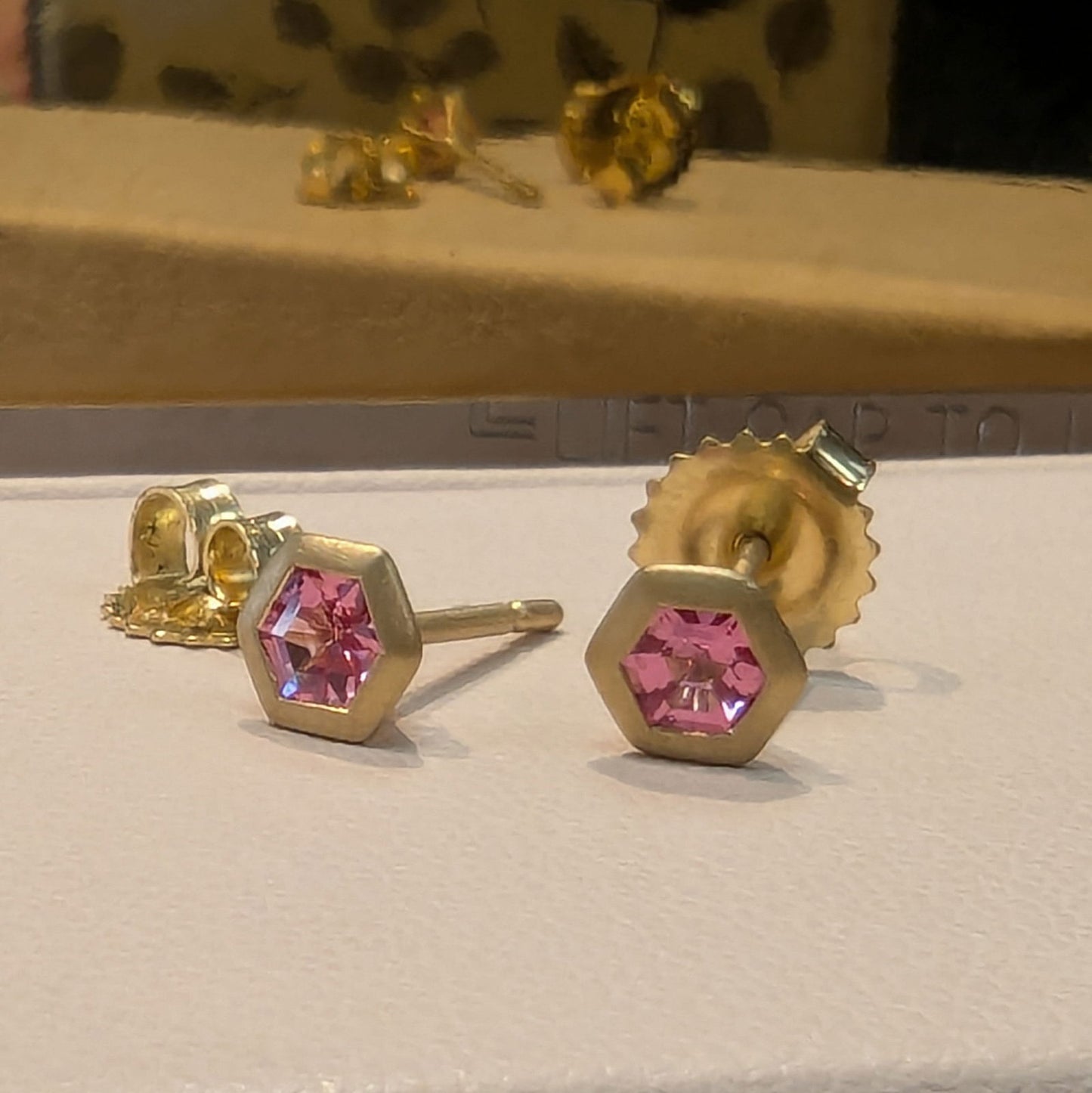 Photo of Pink Spinel Hex Studs in a decorative scene, designed by , available at Plumb Gold & Plumb Silver