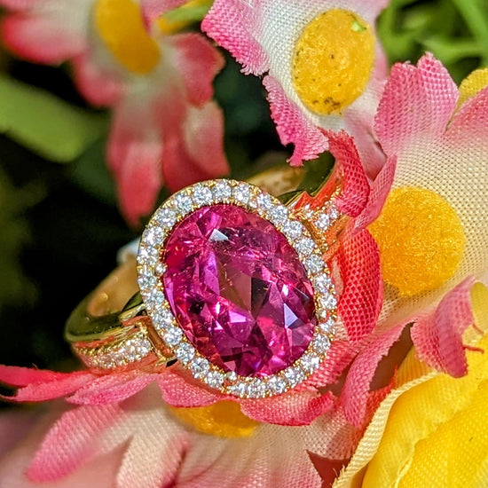 Photo of Pink Tourmaline Halo Ring in a decorative scene, designed by , available at Plumb Gold & Plumb Silver