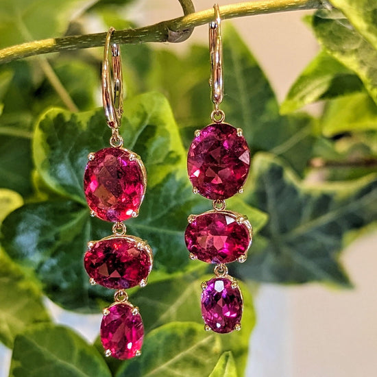 Photo of Pink tourmaline dangle earrings in a decorative scene, designed by , available at Plumb Gold & Plumb Silver