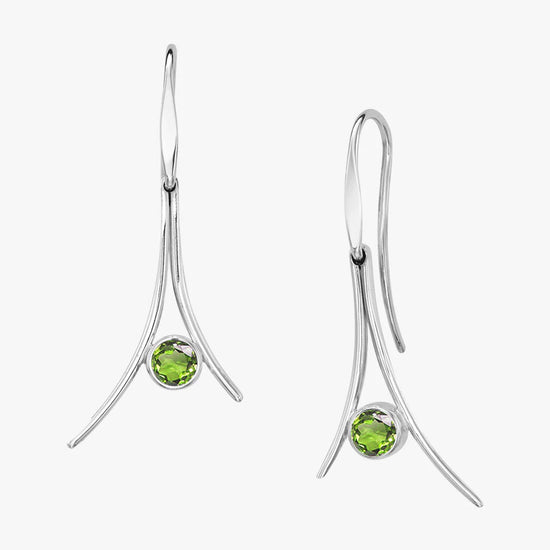 Photo of "Pinnacle" Dangle Earrings in a decorative scene, designed by , available at Plumb Gold & Plumb Silver