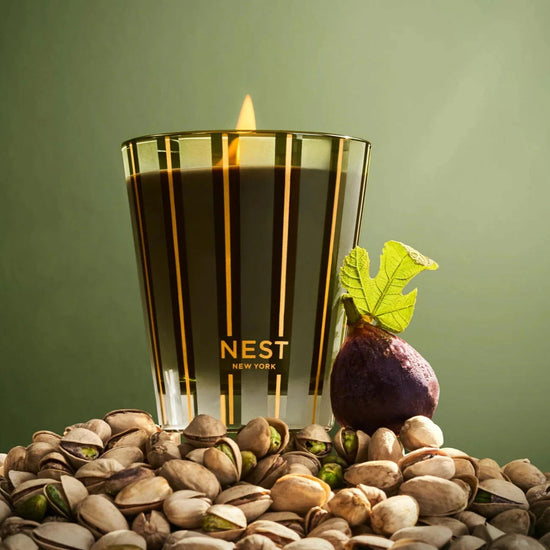 Photo of Pistachio and Wild Fig Candle in a decorative scene, designed by , available at Plumb Gold & Plumb Silver