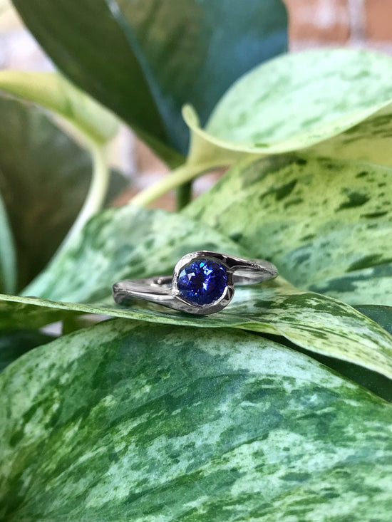 Photo of Plumb Gold Legacy Tanzanite Ring in a decorative scene, designed by , available at Plumb Gold & Plumb Silver