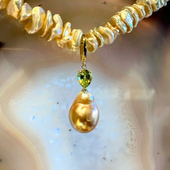 Photo of Plumb Gold Original Pearl Enhancer Pendant in a decorative scene, designed by , available at Plumb Gold & Plumb Silver