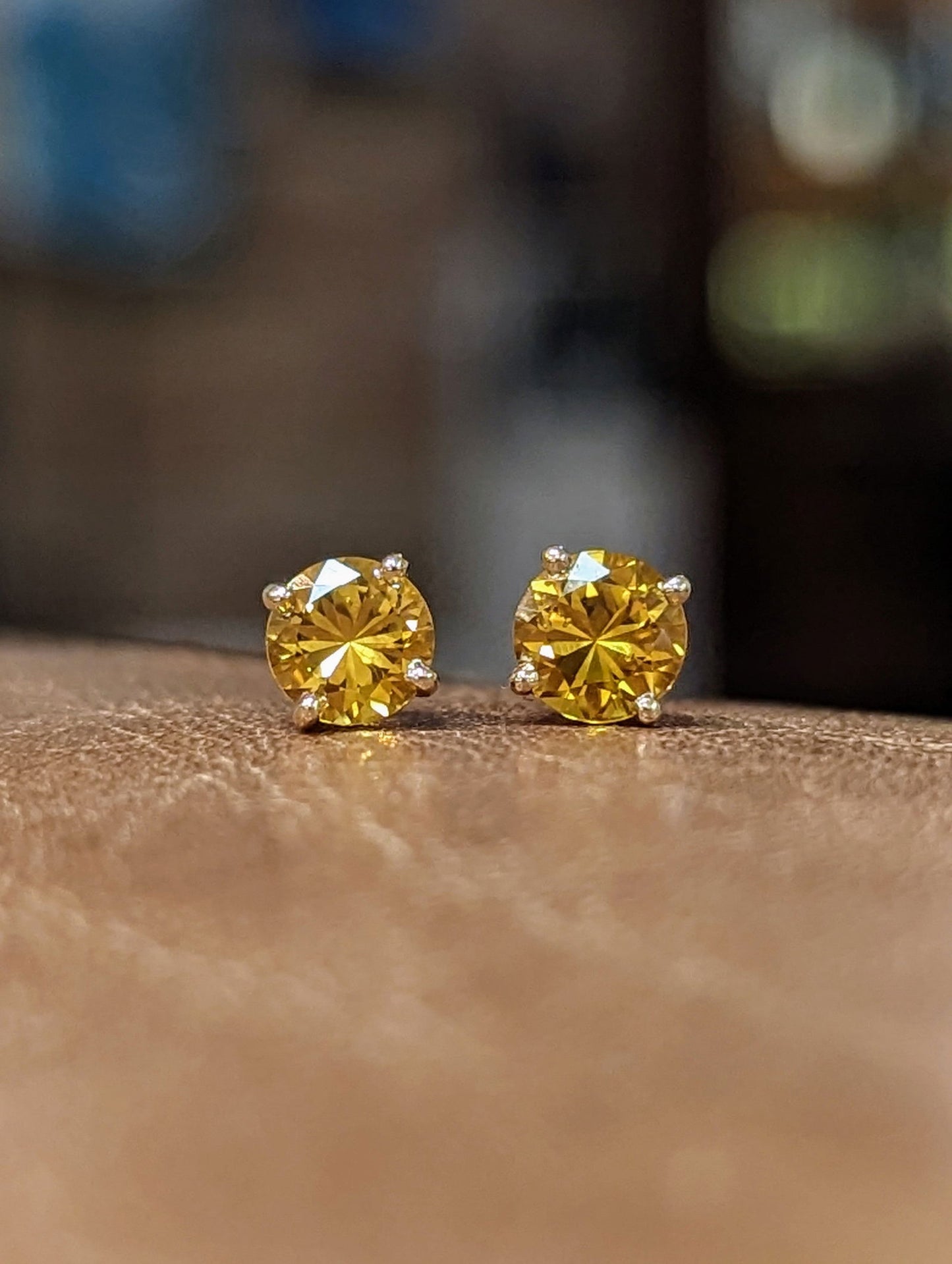 Photo of Plumb Gold Original Yellow Sapphire Studs in a decorative scene, designed by , available at Plumb Gold & Plumb Silver