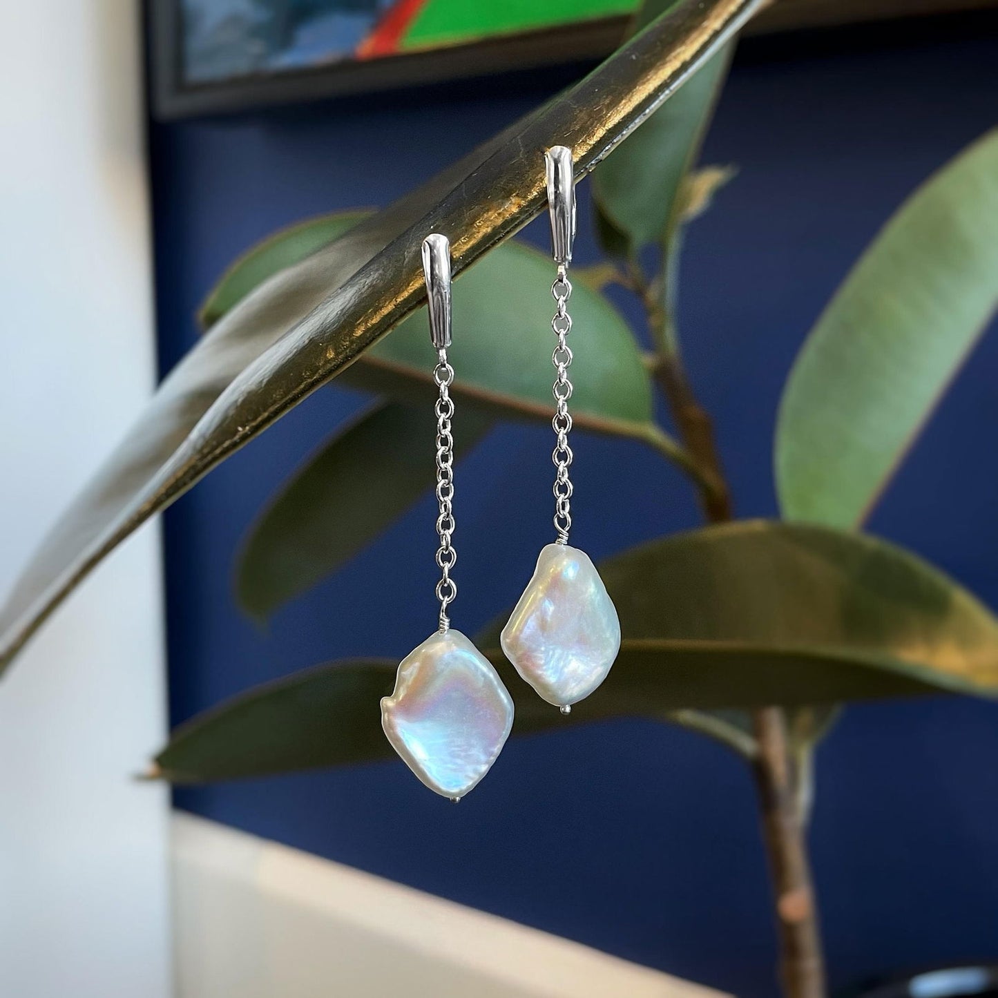 Photo of Plumb Silver Original Pearl Dangles in a decorative scene, designed by , available at Plumb Gold & Plumb Silver