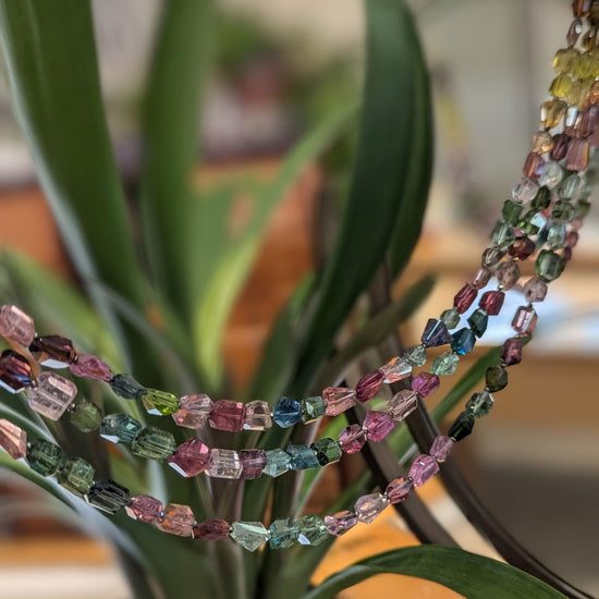 Photo of Plumb Silver Original Rainbow Tourmaline Necklace in a decorative scene, designed by , available at Plumb Gold & Plumb Silver