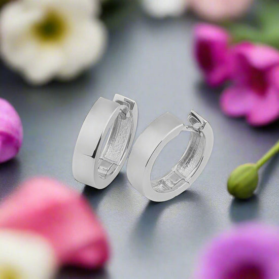 Photo of Polished Simple Hoops in a decorative scene, designed by , available at Plumb Gold & Plumb Silver