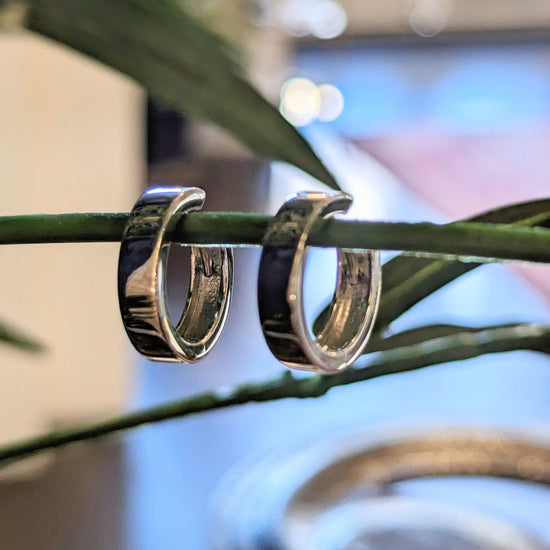 Photo of Polished Simple Hoops in a decorative scene, designed by , available at Plumb Gold & Plumb Silver