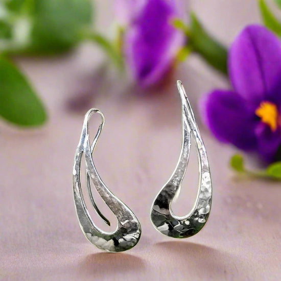 Photo of "Rain Dance" Earrings in a decorative scene, designed by , available at Plumb Gold & Plumb Silver