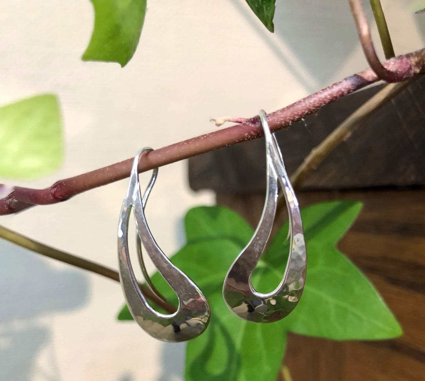 Photo of "Rain Dance" Earrings in a decorative scene, designed by , available at Plumb Gold & Plumb Silver