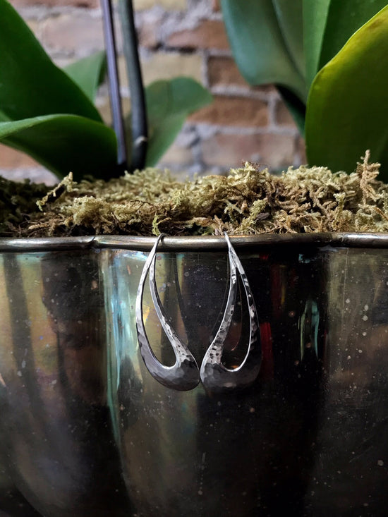Photo of "Rain Dance" Earrings in a decorative scene, designed by , available at Plumb Gold & Plumb Silver