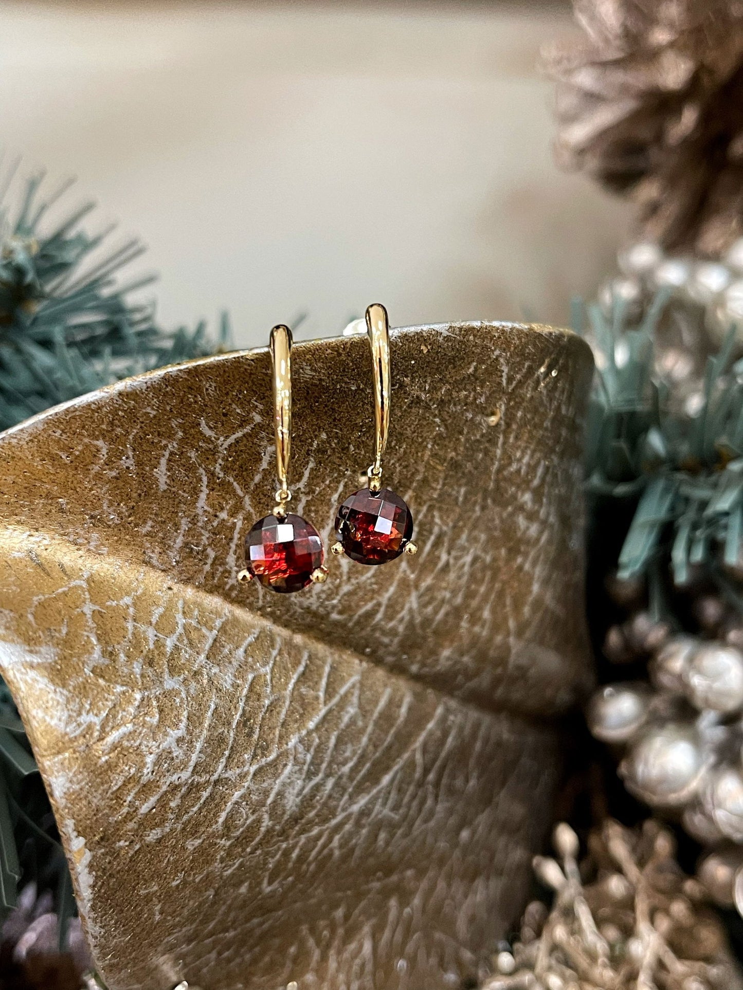 Photo of Red Garnet Dangles in a decorative scene, designed by , available at Plumb Gold & Plumb Silver