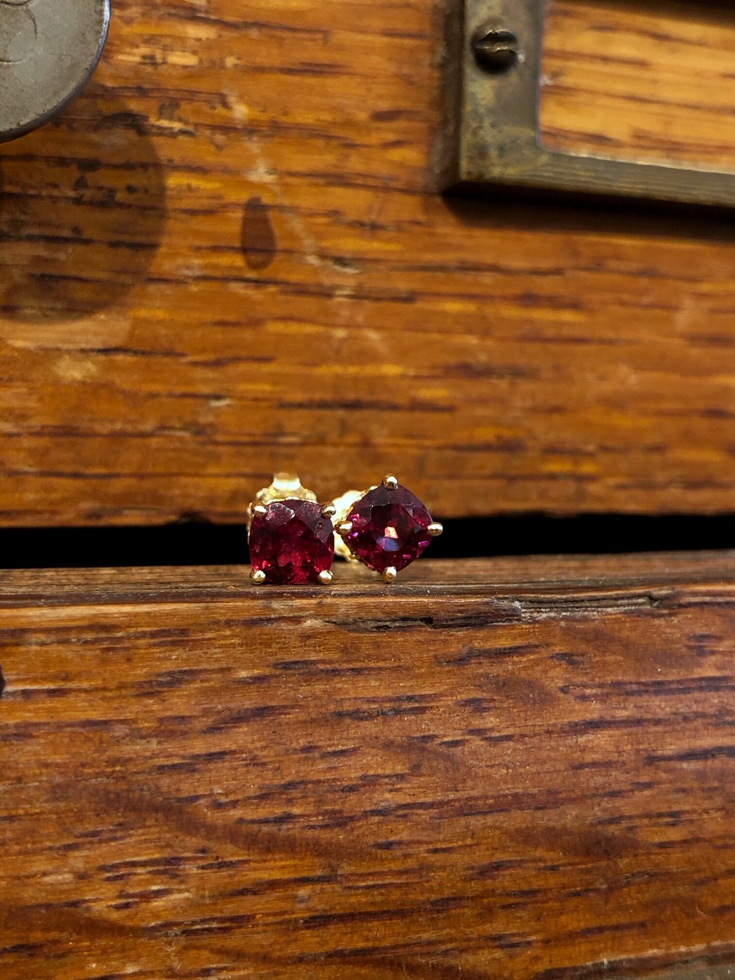 Photo of Red Spinel Studs in a decorative scene, designed by , available at Plumb Gold & Plumb Silver