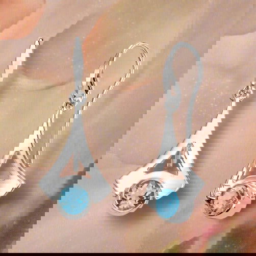 Photo of "Reminisce" Earrings in a decorative scene, designed by , available at Plumb Gold & Plumb Silver