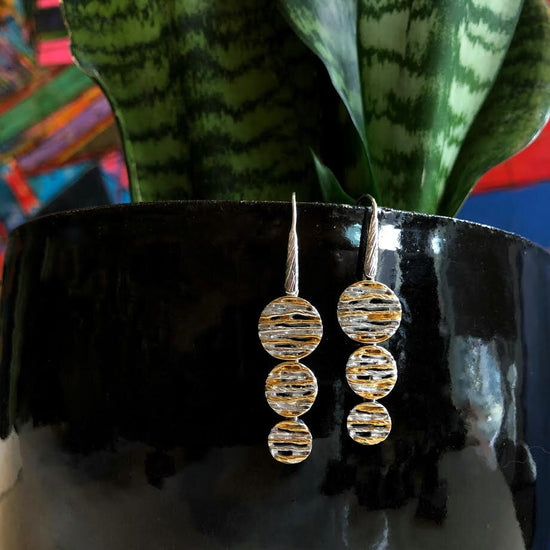 Photo of Rope Dangle Earring in a decorative scene, designed by , available at Plumb Gold & Plumb Silver