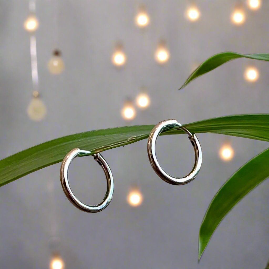 Photo of Round Hinged Hoops in a decorative scene, designed by , available at Plumb Gold & Plumb Silver