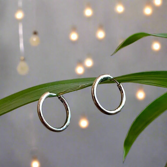 Photo of Round Hinged Hoops in a decorative scene, designed by , available at Plumb Gold & Plumb Silver