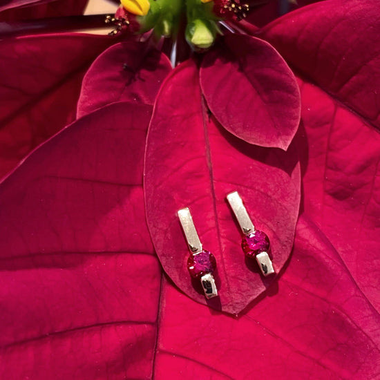 Photo of Ruby Bar Earring in a decorative scene, designed by , available at Plumb Gold & Plumb Silver