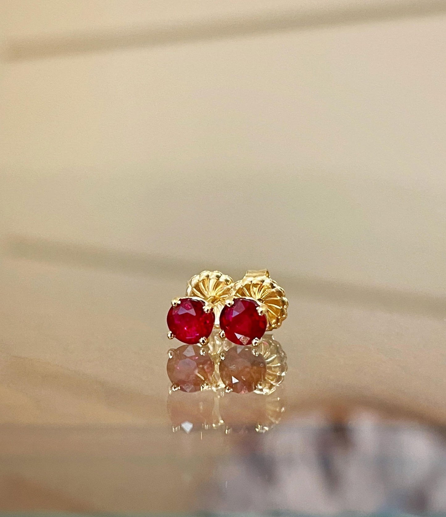 Photo of Ruby Studs in a decorative scene, designed by , available at Plumb Gold & Plumb Silver