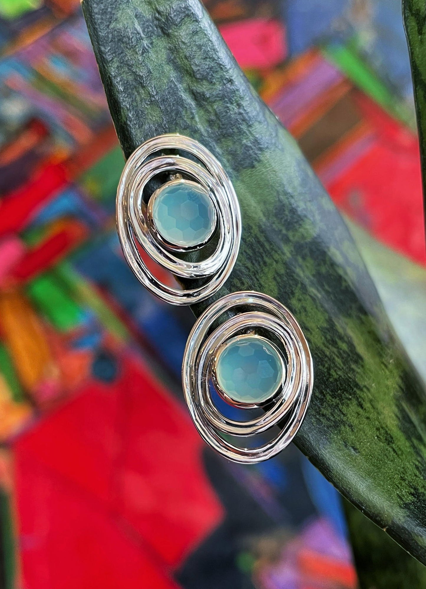 Photo of "Saturn" Earrings in a decorative scene, designed by , available at Plumb Gold & Plumb Silver