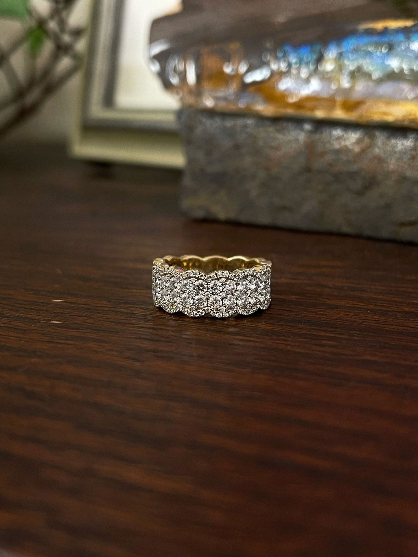 Photo of Scalloped Diamond Ring in a decorative scene, designed by , available at Plumb Gold & Plumb Silver