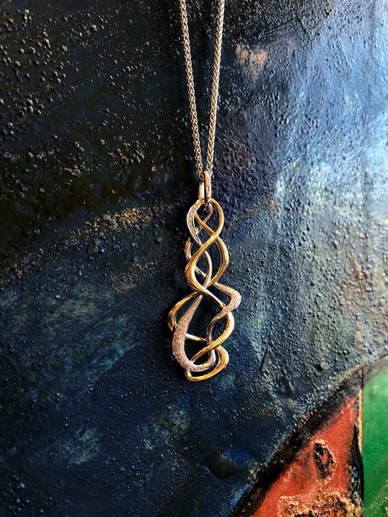 Photo of Scribble Pendant in a decorative scene, designed by , available at Plumb Gold & Plumb Silver
