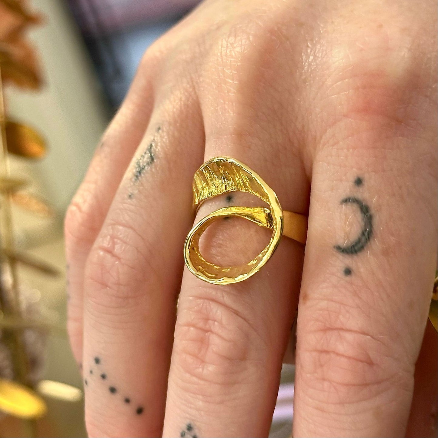 Photo of Seaweed Ring in a decorative scene, designed by -, available at Plumb Gold & Plumb Silver