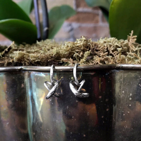 Photo of "Secret Heart" Earrings in a decorative scene, designed by , available at Plumb Gold & Plumb Silver