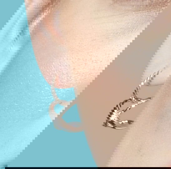 Photo of "Secret Heart" Earrings in a decorative scene, designed by , available at Plumb Gold & Plumb Silver