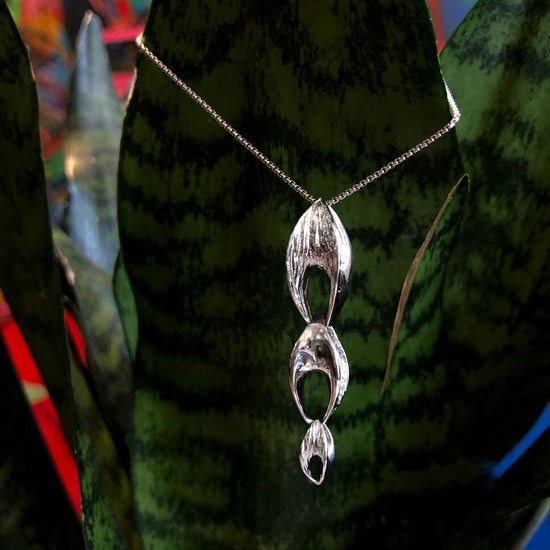 Photo of "Seeds" Pendant in a decorative scene, designed by , available at Plumb Gold & Plumb Silver