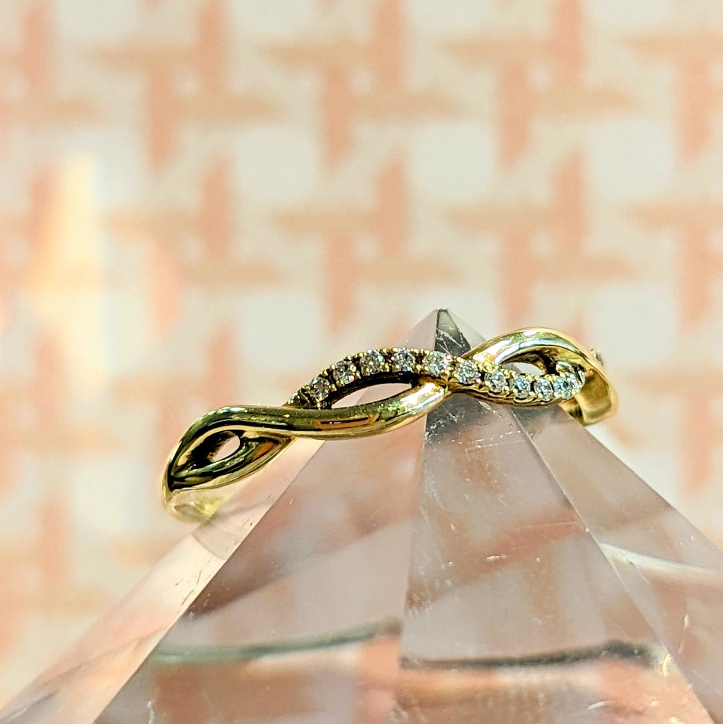 Photo of "Selena" twist band in a decorative scene, designed by , available at Plumb Gold & Plumb Silver