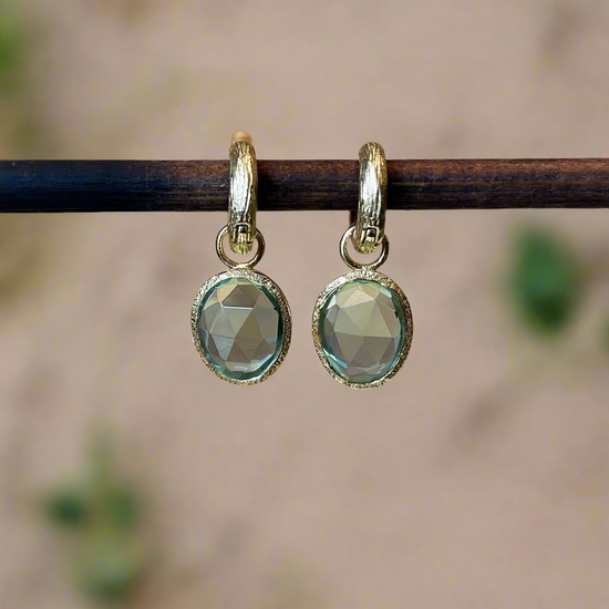 Photo of “Shade” Green Quartz Dangles in a decorative scene, designed by , available at Plumb Gold & Plumb Silver