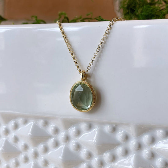 Photo of “Shade” Green Quartz Pendant in a decorative scene, designed by , available at Plumb Gold & Plumb Silver