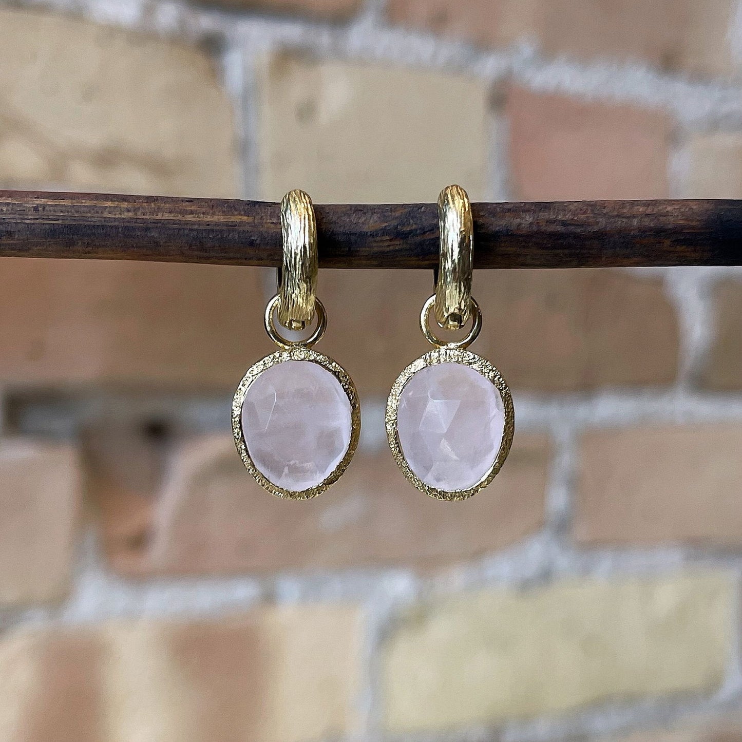 Photo of “Shade” Rose Quartz Dangles in a decorative scene, designed by , available at Plumb Gold & Plumb Silver