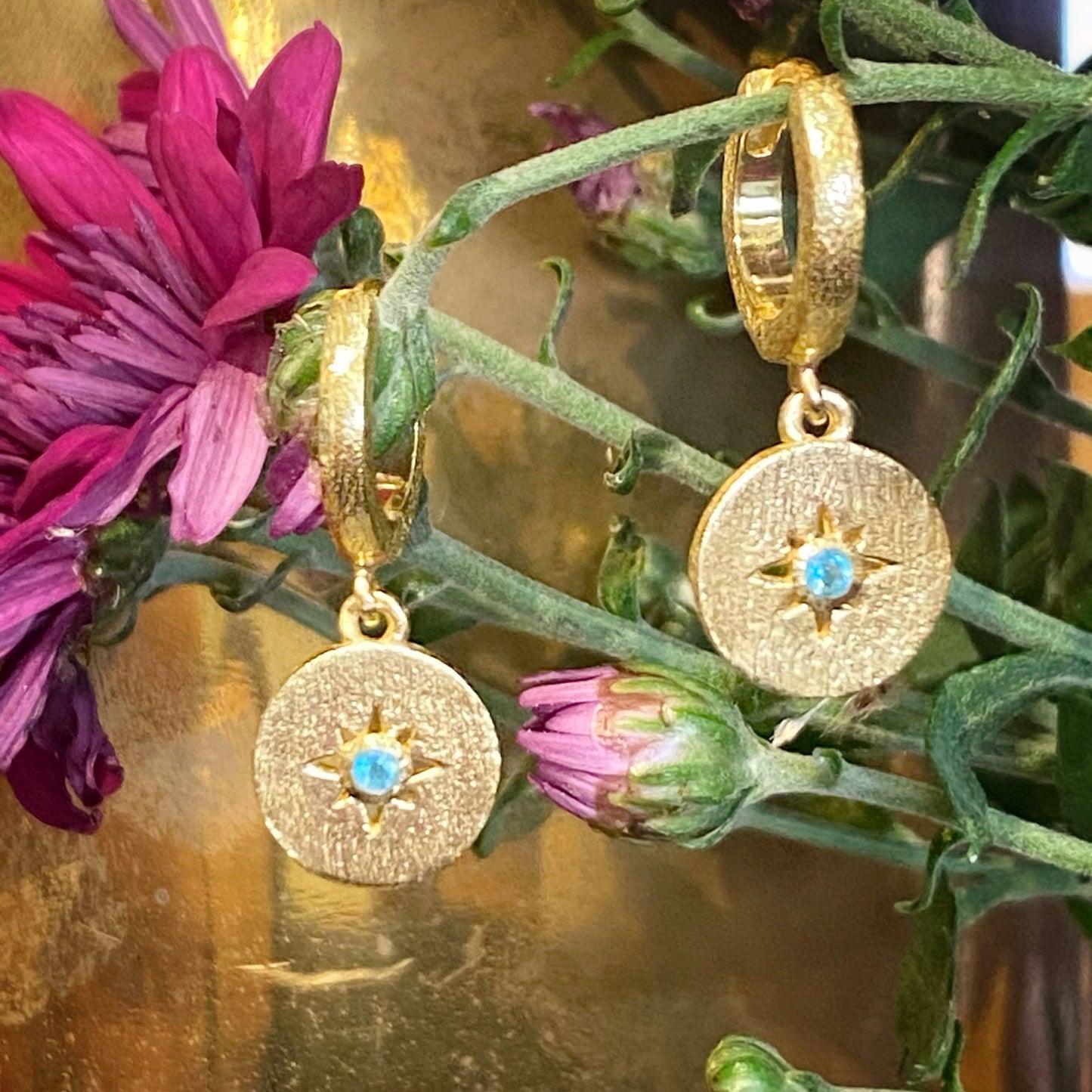 Photo of Shine Apatite Earrings in a decorative scene, designed by -, available at Plumb Gold & Plumb Silver