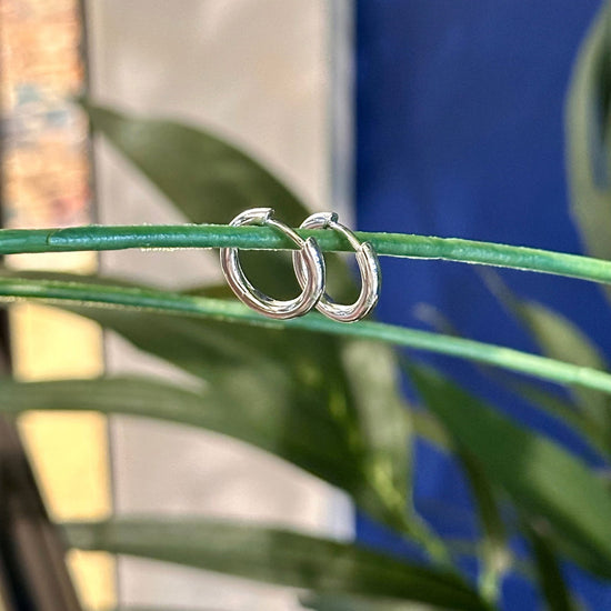 Photo of Silver 15mm Round Hoop in a decorative scene, designed by , available at Plumb Gold & Plumb Silver