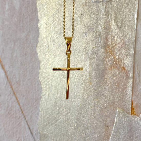 Photo of Slim Cross in a decorative scene, designed by , available at Plumb Gold & Plumb Silver