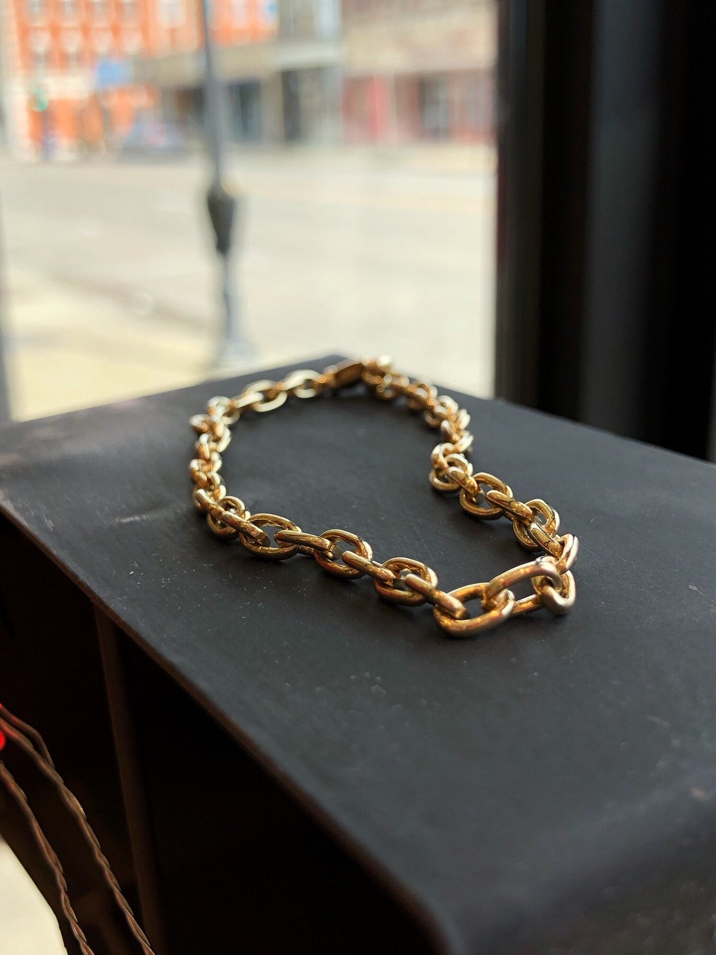 Photo of Solid Oval Link Bracelet in a decorative scene, designed by , available at Plumb Gold & Plumb Silver