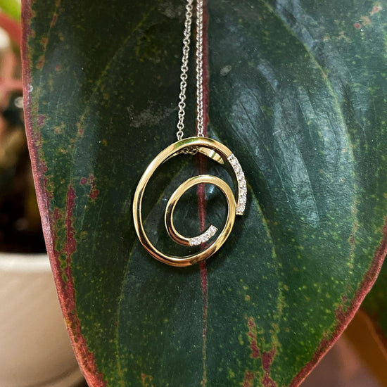Photo of Spiral Pendant in a decorative scene, designed by , available at Plumb Gold & Plumb Silver