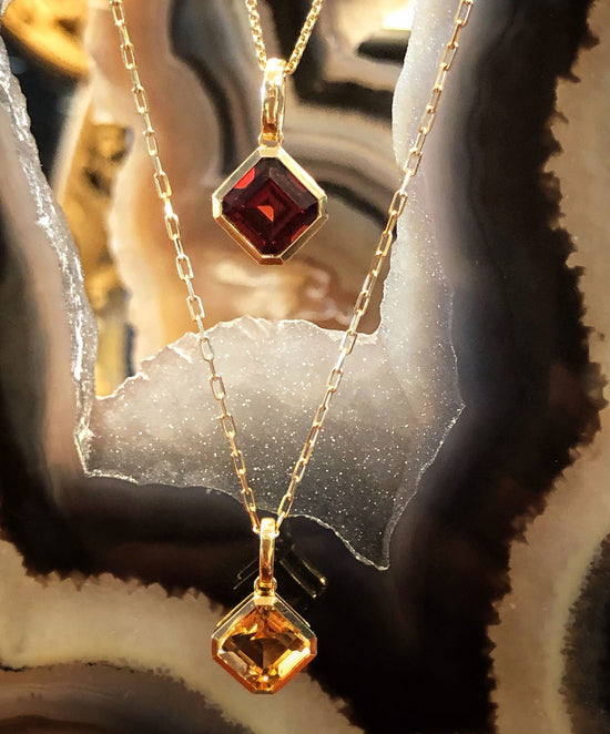 Photo of Square Gemstone Pendant in a decorative scene, designed by , available at Plumb Gold & Plumb Silver